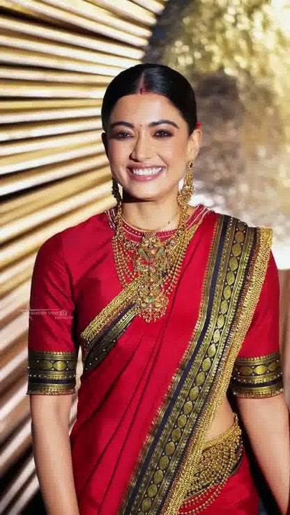Celebrity-Inspired Red Silk Saree with Black & Gold Temple Border (Rashmika Wedding Style)